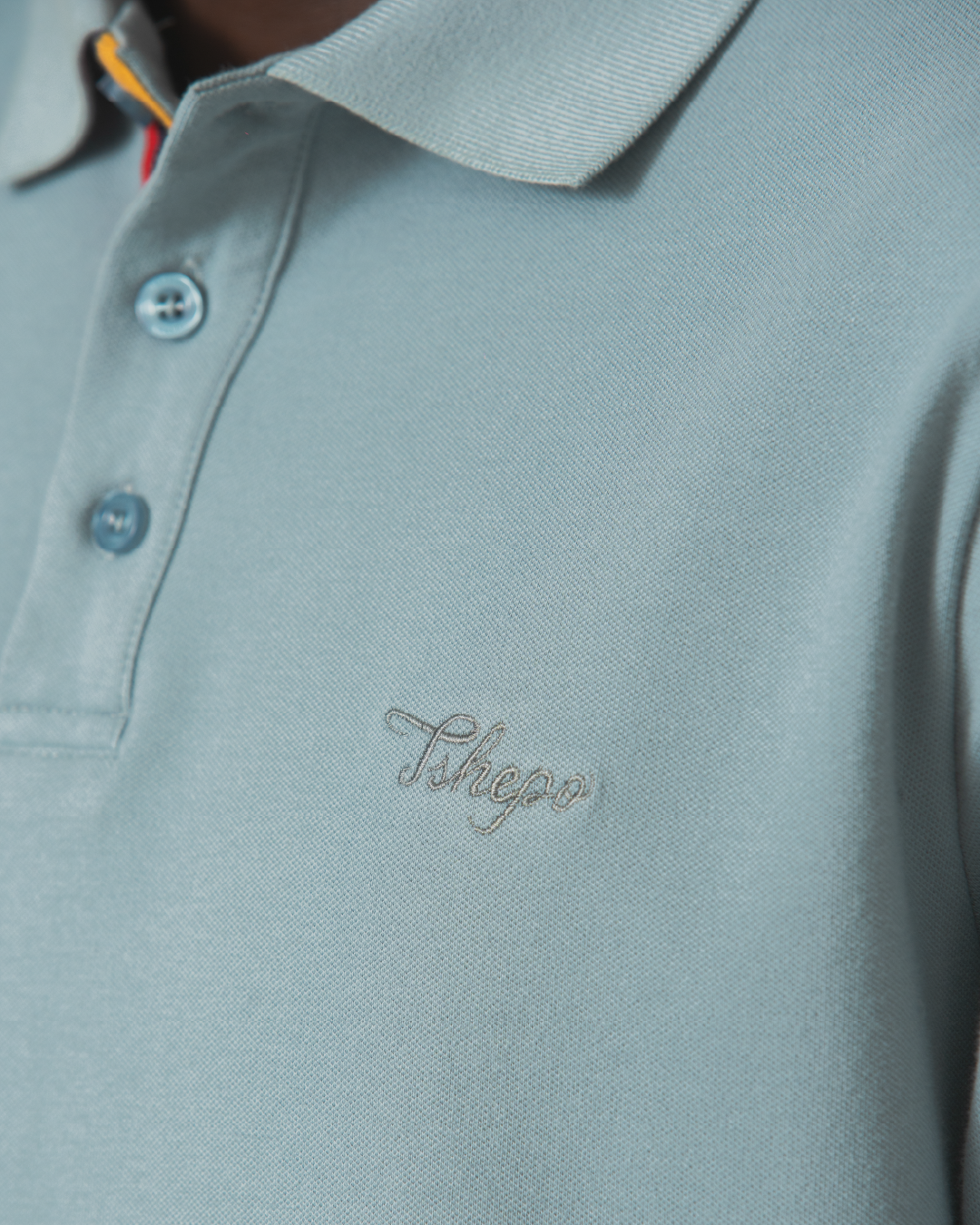 Up close embroidered Sage TSHEPO Golfer