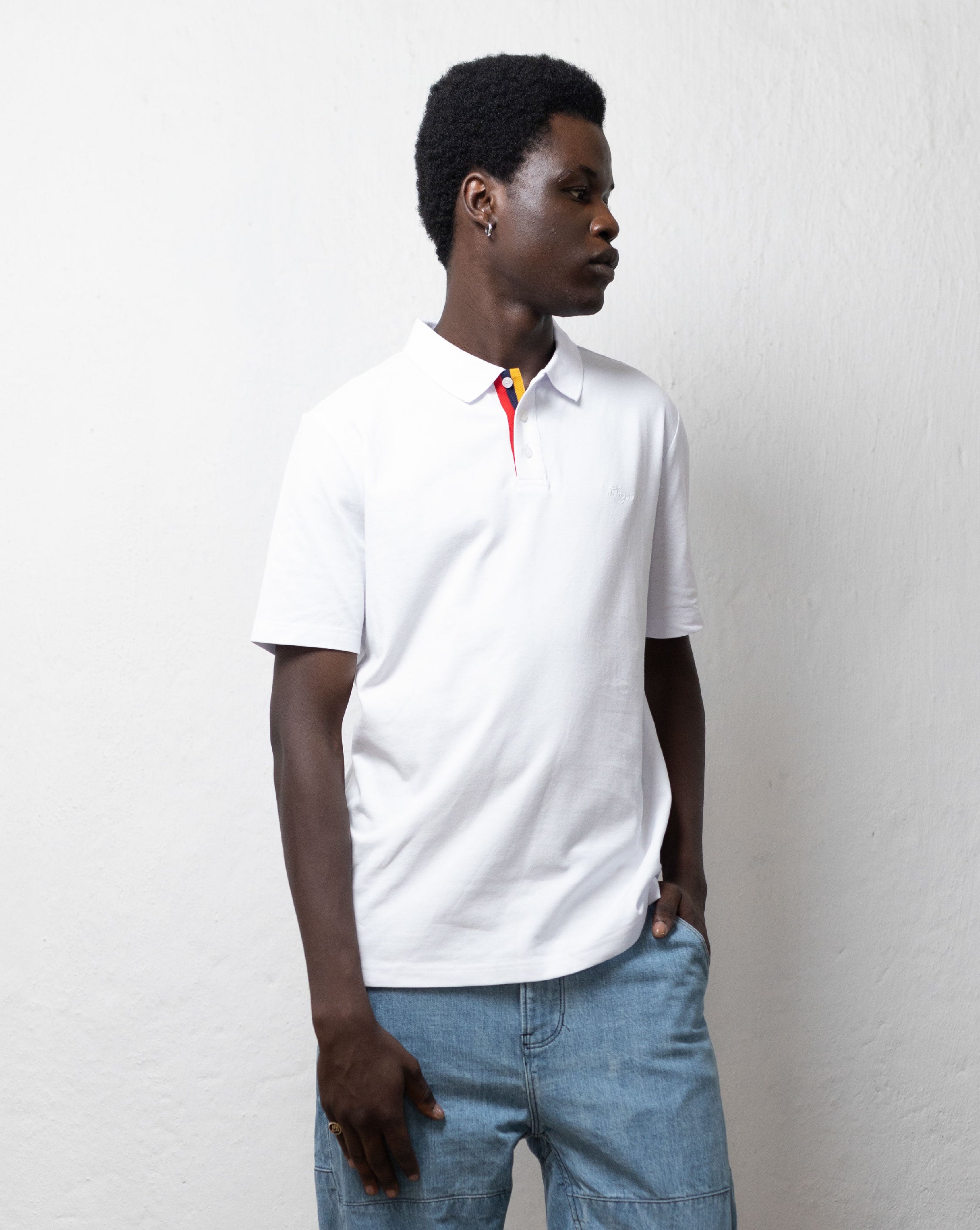 TSHEPO model in a white polo.