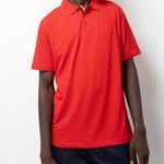 Model wearing the red TSHEPO Golf Shirt