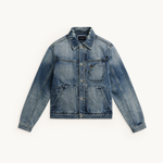 Front view of a blue TSHEPO denim jacket with a button-up front, chest pocket, and two large front patch pockets, laid flat against a light off-white background.