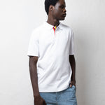 TSHEPO model in a white polo.