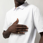 TSHEPO Polo in white worn by a model.