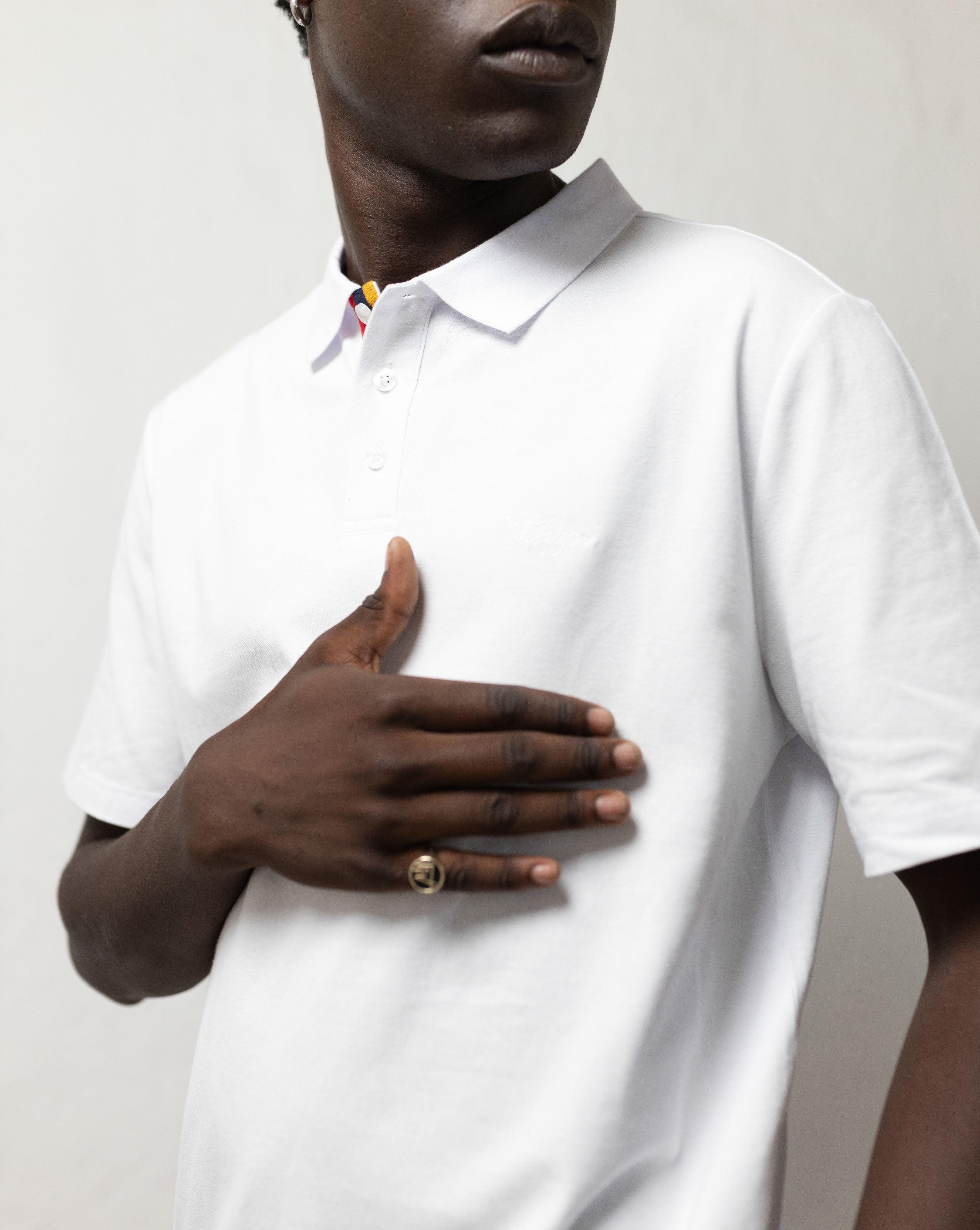 TSHEPO Polo in white worn by a model.